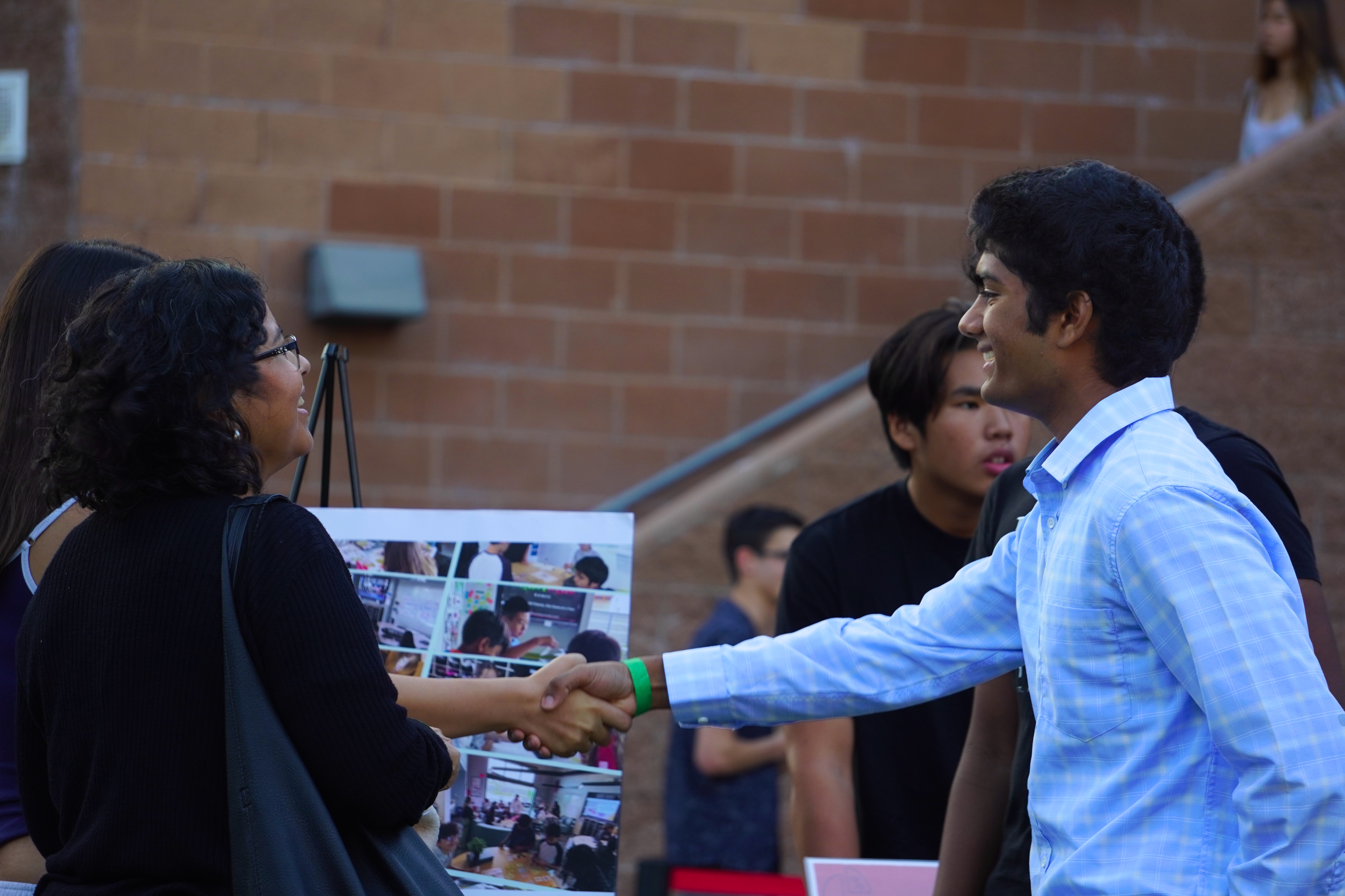 FLI student handshake at networking event